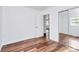Bright bedroom featuring laminate flooring, a closet with mirrored doors, and a window at 2548 Milton Ave, Gastonia, NC 28052