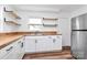 Modern kitchen with stainless steel appliances, butcher block countertops, and open shelving at 2548 Milton Ave, Gastonia, NC 28052