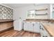 Well-lit laundry area with a washing machine, built-in shelving, and butcher block countertops at 2548 Milton Ave, Gastonia, NC 28052