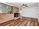Spacious living room featuring a decorative brick wall and fireplace, with modern flooring at 2548 Milton Ave, Gastonia, NC 28052
