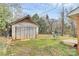 Backyard featuring a weathered outbuilding or garage with a swing nearby at 2548 Milton Ave, Gastonia, NC 28052