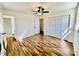 Bright bedroom with hardwood floors, closet, ceiling fan, and access to the bathroom at 2604 Oxford Cir, Lancaster, SC 29720