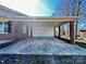 A spacious covered carport attached to a brick house, offering sheltered parking at 2604 Oxford Cir, Lancaster, SC 29720