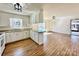 Bright kitchen featuring white cabinetry, stainless steel appliances, backsplash, and hardwood floors at 2604 Oxford Cir, Lancaster, SC 29720