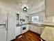 Bright kitchen featuring white cabinetry, stainless steel appliances and hardwood floors at 2604 Oxford Cir, Lancaster, SC 29720