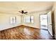 Open concept living room with hardwood floors, a ceiling fan, and ample natural light at 2604 Oxford Cir, Lancaster, SC 29720