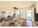 Cozy living room featuring hardwood floors, a ceiling fan, and ample natural light at 2604 Oxford Cir, Lancaster, SC 29720