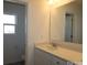 Bright bathroom featuring a large mirror, white vanity, and natural light from the window at 3511 Nimbell Rd, Monroe, NC 28110