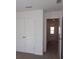 Hallway featuring a large closet with white double doors and an open doorway leading to a bedroom at 3511 Nimbell Rd, Monroe, NC 28110