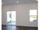 Bright living room with dark wood floors, a sliding glass door, and a large window at 3511 Nimbell Rd, Monroe, NC 28110