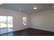 Bright living room with dark wood floors, a sliding glass door, and a large window at 3511 Nimbell Rd, Monroe, NC 28110