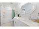A white bathroom with a large decorative mirror, modern fixtures, and a shower-tub combo at 3512 Auburn Curb Rd, Charlotte, NC 28217