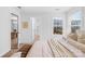 Bright bedroom featuring neutral tones, a window view, and doorway to adjacent bathroom at 3512 Auburn Curb Rd, Charlotte, NC 28217
