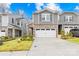 Charming townhome exterior with a two-car garage, stone accents, and a well-kept lawn at 3512 Auburn Curb Rd, Charlotte, NC 28217