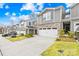 Modern townhome exteriors with beautiful stone accents, two-car garages, and well-maintained landscaping create curb appeal at 3512 Auburn Curb Rd, Charlotte, NC 28217