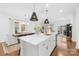 Open kitchen featuring a large island, modern lighting, and stainless steel appliances at 3512 Auburn Curb Rd, Charlotte, NC 28217
