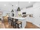 Beautiful kitchen with white cabinets, countertops, and island with bar stool seating at 3512 Auburn Curb Rd, Charlotte, NC 28217