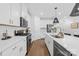 Well-equipped kitchen with modern appliances, white cabinetry, and stylish backsplash at 3512 Auburn Curb Rd, Charlotte, NC 28217