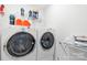 Modern laundry room featuring a front-load washer and dryer, shelving, and ample space for laundry tasks at 3512 Auburn Curb Rd, Charlotte, NC 28217