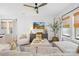 Cozy living room with a modern ceiling fan, large windows, and comfortable seating at 3512 Auburn Curb Rd, Charlotte, NC 28217