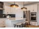 Modern kitchen with white cabinets, stainless steel appliances, an island with seating, and stylish pendant lighting at 3523 Rapport Ct # 026, Lancaster, SC 29720