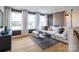 Bright living room with large windows, hardwood floors, and a comfortable sectional sofa at 3523 Rapport Ct # 026, Lancaster, SC 29720