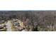 A high aerial view of the house and its neighborhood, with mature trees and surrounding woods at 4201 Winedale Ln, Charlotte, NC 28205