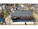 An aerial view of a brick house with a large concrete patio perfect for entertaining at 4201 Winedale Ln, Charlotte, NC 28205