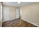 This bedroom features hardwood floors, neutral walls, and doors to the closet and hallway at 4201 Winedale Ln, Charlotte, NC 28205