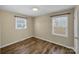 This bedroom features hardwood floors, neutral walls, and a window that lets in ample light at 4201 Winedale Ln, Charlotte, NC 28205