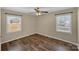This bedroom features hardwood floors, neutral walls, and two windows that let in ample light at 4201 Winedale Ln, Charlotte, NC 28205
