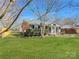 Cozy home with neat landscaping, complementing the classic architectural details and enhancing the property's overall charm at 4201 Winedale Ln, Charlotte, NC 28205