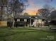 Charming single-story home with a well-manicured front lawn and a welcoming porch, perfect for enjoying peaceful evenings at 4201 Winedale Ln, Charlotte, NC 28205