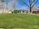 Charming house with a spacious front lawn, mature trees, and a well-kept exterior, offering great curb appeal at 4201 Winedale Ln, Charlotte, NC 28205
