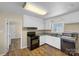 Traditional kitchen with white cabinets, a black range, and stainless steel sink at 4201 Winedale Ln, Charlotte, NC 28205