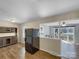 Kitchen with a black refrigerator, eat-in nook with cabinets, and an opening into a sunny living room at 4201 Winedale Ln, Charlotte, NC 28205
