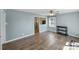 Living room showcasing laminate flooring, neutral walls, and an opening to another room with natural light at 4201 Winedale Ln, Charlotte, NC 28205