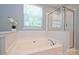 Elegant bathroom features a soaking tub, separate shower, and window with natural light at 530 Pate Dr, Fort Mill, SC 29715