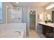 Well-lit bathroom with a glass shower, soaking tub, and modern vanity at 530 Pate Dr, Fort Mill, SC 29715