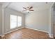 Bright, empty bedroom featuring wood-look flooring, a ceiling fan, and a double window at 530 Pate Dr, Fort Mill, SC 29715