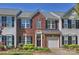 Charming brick townhome featuring an attached garage, black shutters, and a landscaped front yard at 530 Pate Dr, Fort Mill, SC 29715