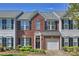 Charming brick townhome featuring an attached garage, black shutters, and a landscaped front yard at 530 Pate Dr, Fort Mill, SC 29715