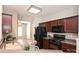 A view of the kitchen with dark wood cabinetry and modern black appliances at 530 Pate Dr, Fort Mill, SC 29715