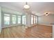 Spacious living room filled with natural light boasting wood floors, modern lighting and neutral paint at 530 Pate Dr, Fort Mill, SC 29715
