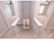 Carpeted staircase leading to a lower level with two rooms and wood flooring at 530 Pate Dr, Fort Mill, SC 29715