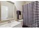 Bathroom featuring a sink with an ornate-framed mirror, a toilet, and a shower with a checkered curtain at 558 Rough Hewn Ln, Rock Hill, SC 29730