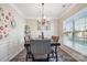Dining area featuring a modern chandelier and a view from the large window at 558 Rough Hewn Ln, Rock Hill, SC 29730