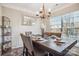 Bright dining room with a table set for six, decorative mirror, and chandelier at 558 Rough Hewn Ln, Rock Hill, SC 29730
