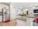 Kitchen with stainless steel appliances, granite counters, breakfast bar, and wood flooring at 558 Rough Hewn Ln, Rock Hill, SC 29730