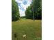 Expansive backyard featuring a large lawn and surrounding mature trees at 607 Anthony Grove Rd, Crouse, NC 28033